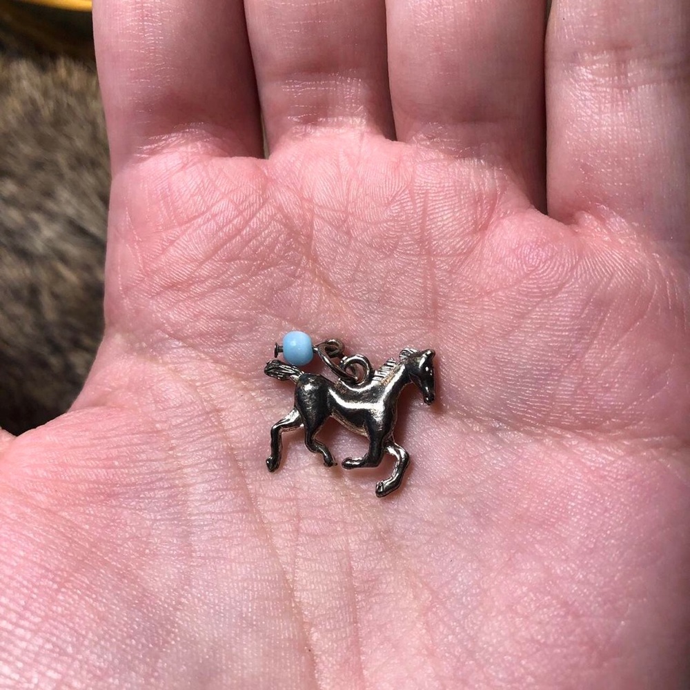 Silver toned running horse pendant with blue glass bead